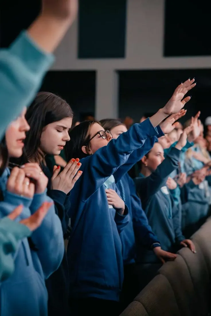 A group wearing matching blue sweatshirts, a great example of custom apparel from bulk screen print shirts services.