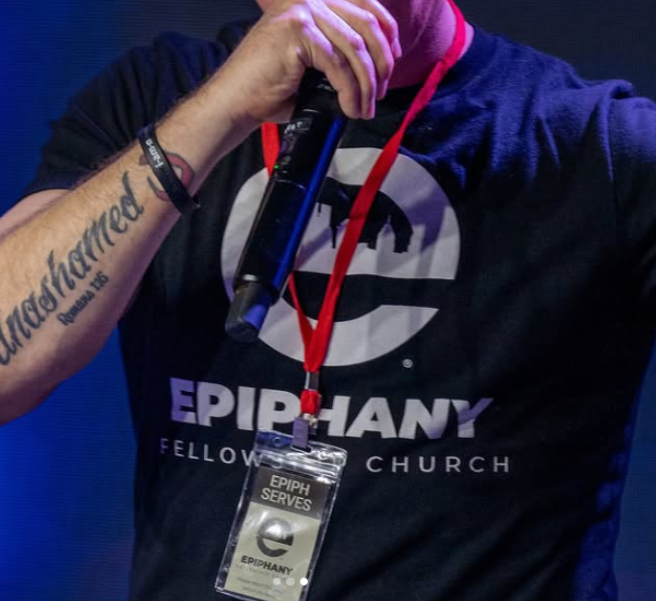 Speaker wearing Epiphany Fellowship Church t-shirt during service, showing how can churches use t-shirts to promote events and build unity.